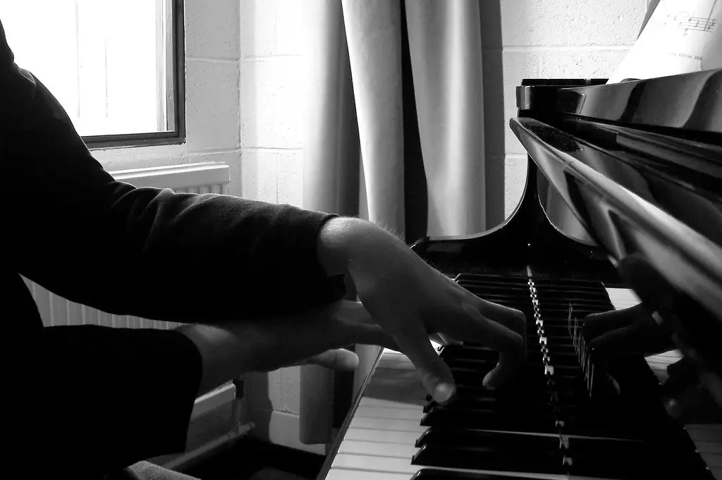 Two Hands on a piano symbolizing "discipline of practice"