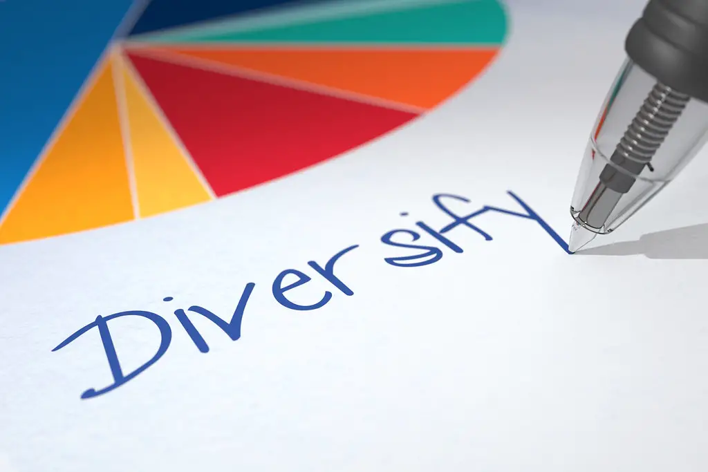 A pie chart with a pen writing "Diversify"