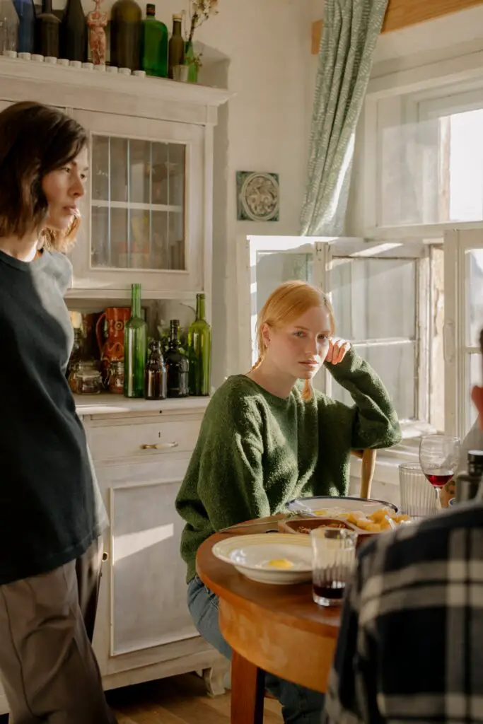 students eating at a table, symbolizing the joint household